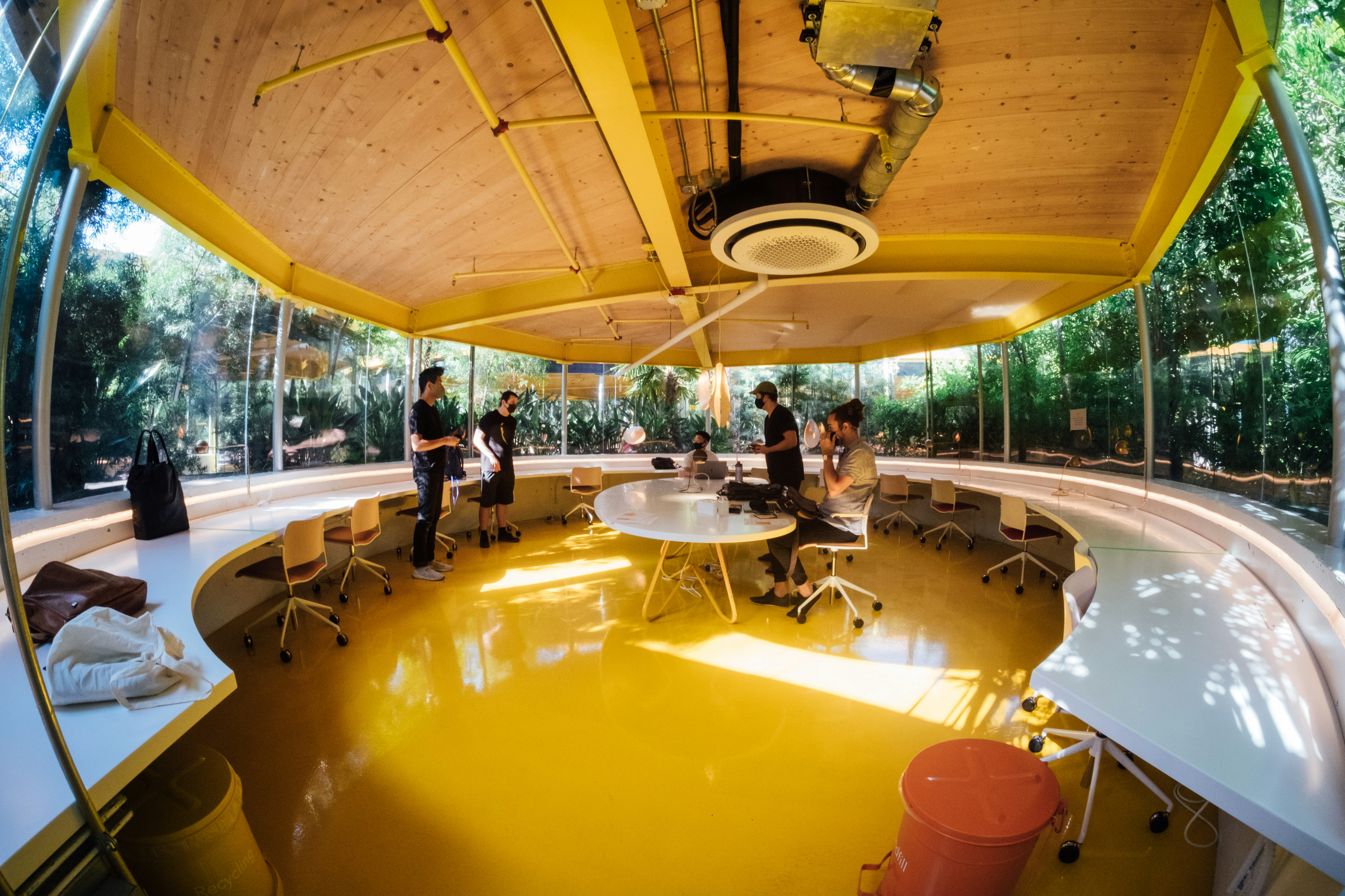 people standing and sitting on chairs inside building